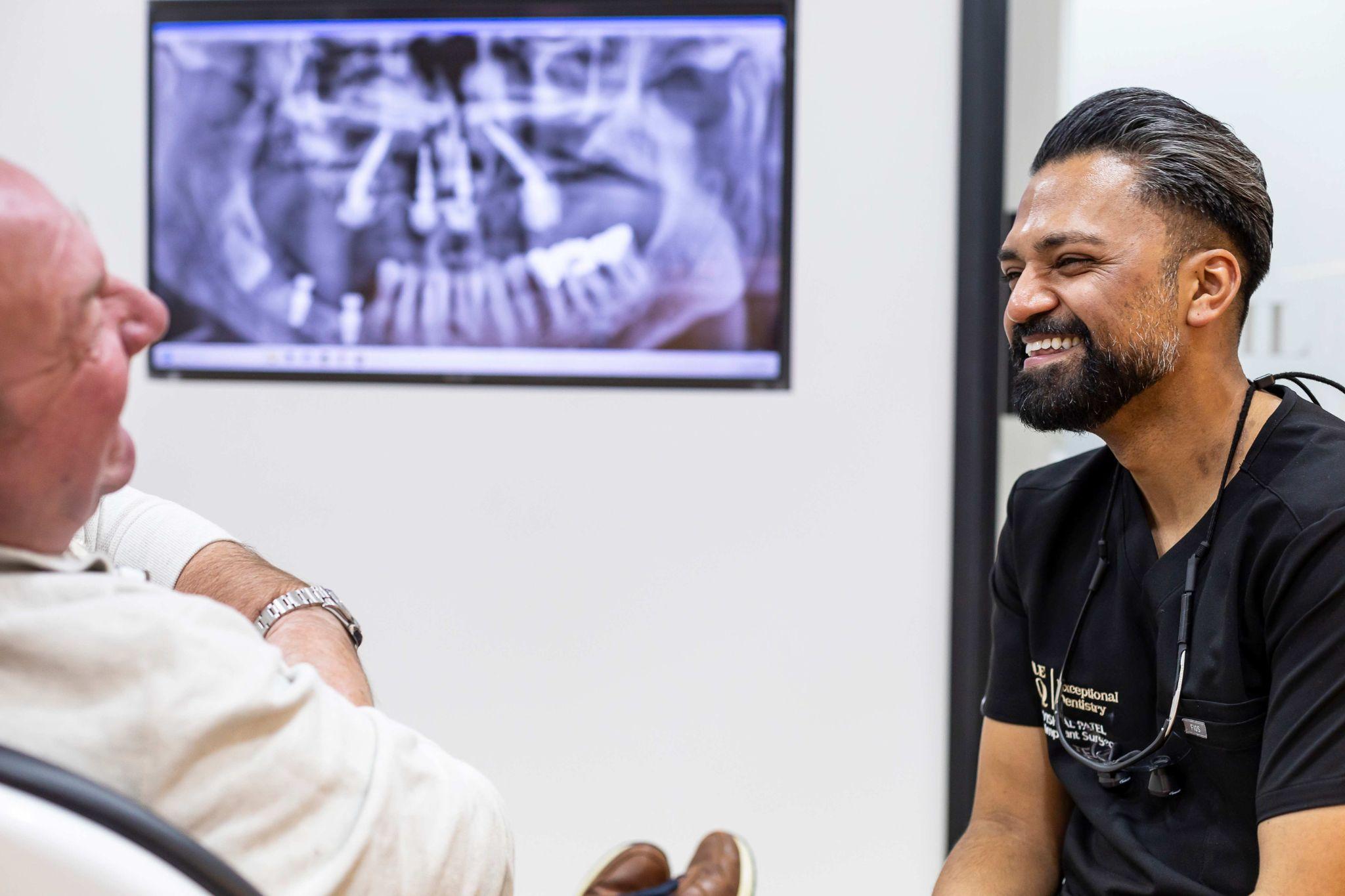 happy patient consultation dental implants Essex SmileHQ Brentwood improved smile confidence Dr Vishal Patel