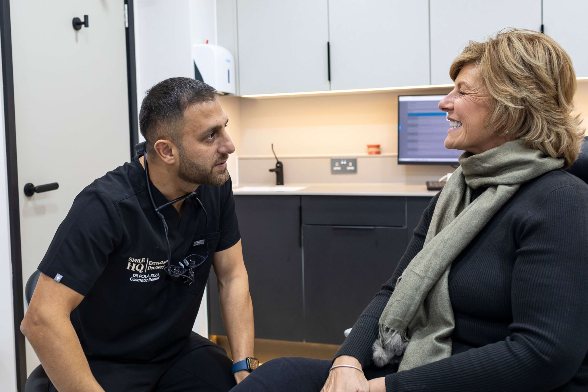 Cosmetic dentist Dr Pola Reza discussing customised teeth whitening options with patient in dental surgery