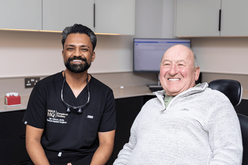 Dr Vishal Patel with a smiling dental implant patient at SmileHQ in Brentwood