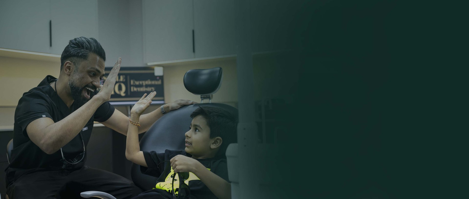 SmileHQ dentist high-fiving a young patient in Brentwood