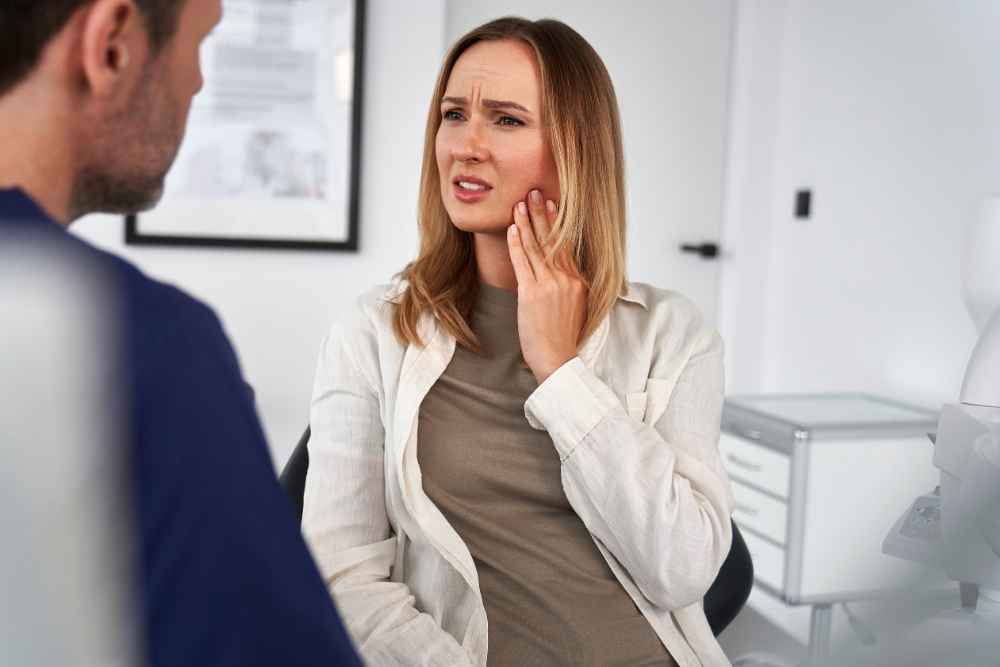 Patient discussing jaw pain and bruxism symptoms with a dentist