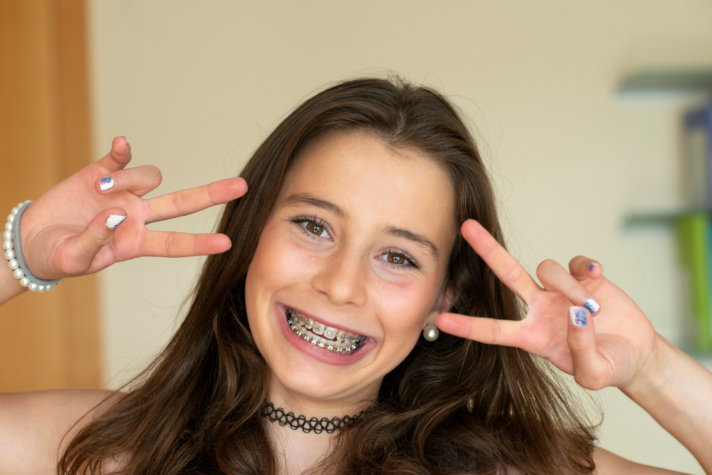 Teenage girl smiling with fixed braces on her teeth