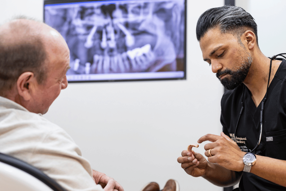 Implant Surgeon Dr Vishal Patel consulting with a patient about dental implants in Essex