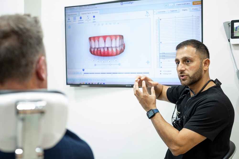 SmileHQ dentist discussing bruxism treatment with a patient in Brentwood